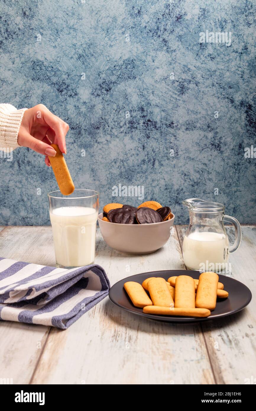 Leckere Kekse mit Milchglas auf einer Tischplatte Stockfoto