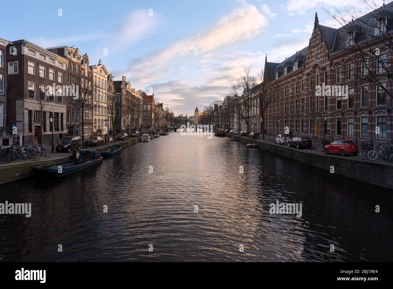 Historische alte Häuser am Kanal und Gebäude eines breiten Abschnitts des Amsterdamer Kanalnetzes, Niederlande. Stockfoto