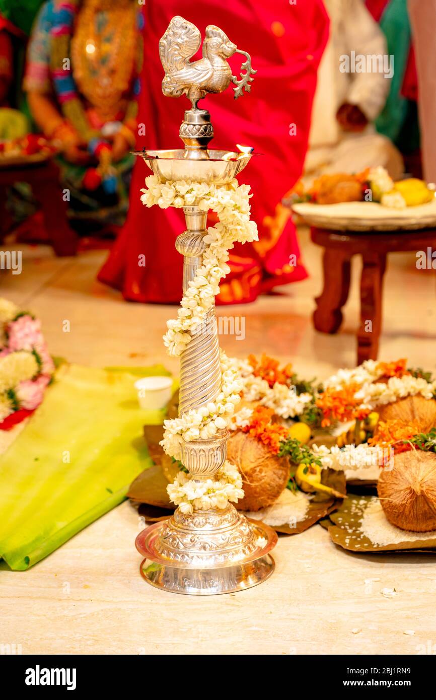 Traditionelle silberne Öllampe brennt bei einer südindischen Hindu-Hochzeit Stockfoto