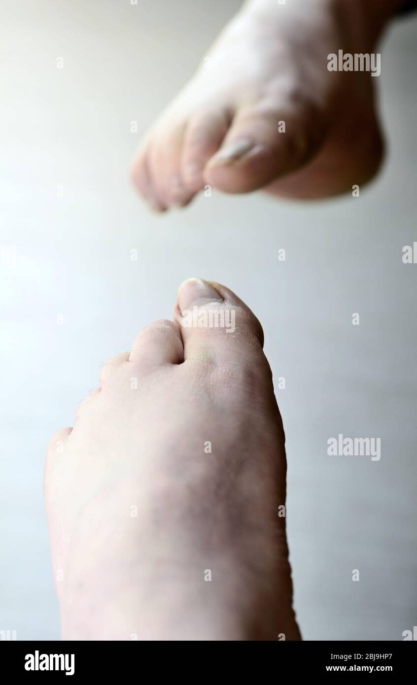 Fuß gegen Spiegel prüfen. Der Fuß ist während der Kontrolle im Spiegel reflektiert. Stockfoto