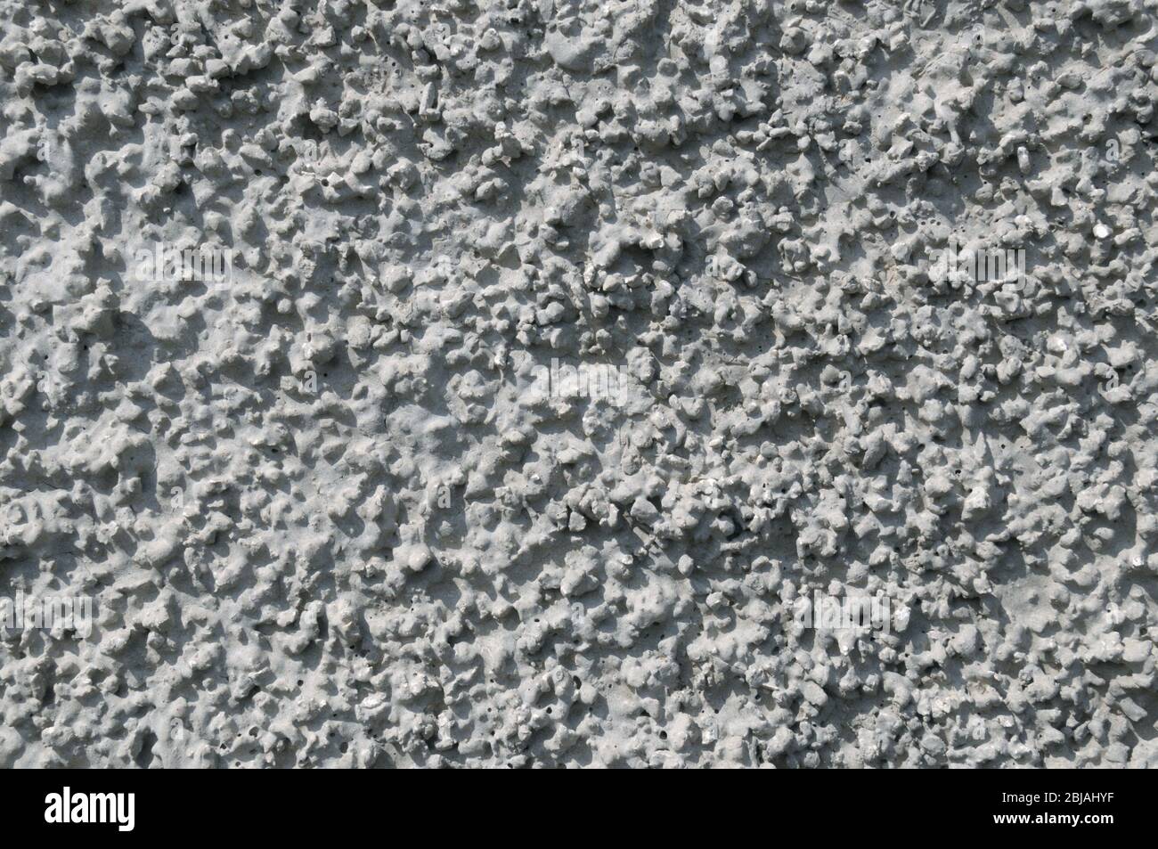 Zementputz auf Betonwand. Grauer Hintergrund. Stockfoto
