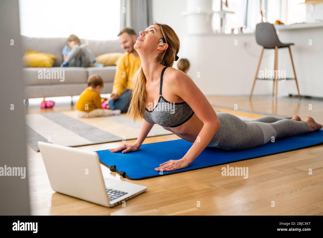 Junge Frau übt Yoga zu Hause aus. Fitness, Workout, gesundes Leben und Diät-Konzept. Stockfoto