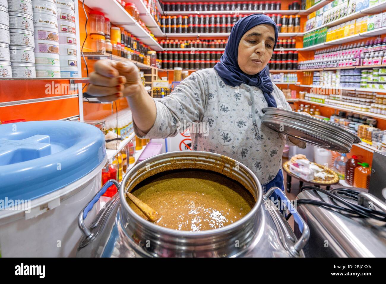 Agadir, Marokko - 19. März 2020: Frau, die frisch zubereitete, Bio-Erdnussbutter auf dem Markt in Afrika verkauft Stockfoto