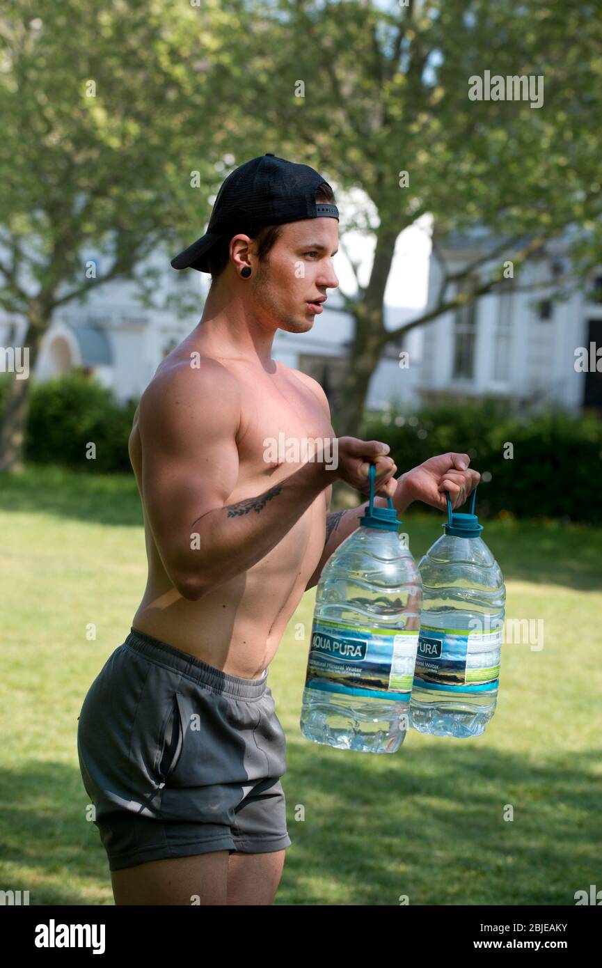 Tower Hamlets, London, Großbritannien. Eddy , ursprünglich aus Litauen, trainiert mit Wasserflaschen im Park. Eddie, origally aus Litauen, übt mit Stockfoto