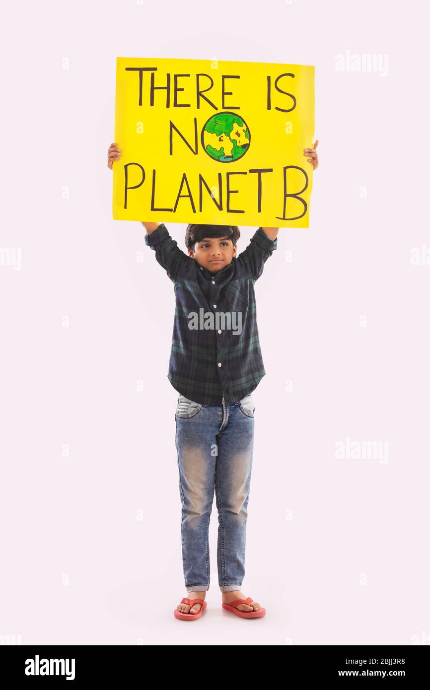 Junger Junge, der ein Plakat in der Hand hält mit einer Botschaft, Mutter Erde zu retten. (Kinder) Stockfoto