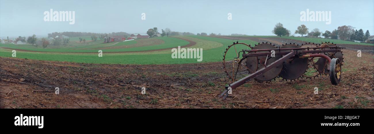 Landwirtschaftliche Maschine in einem Feld im frühen Frühjahr. Amish Gemeinde. Delta, Pennsylvania. USA Stockfoto
