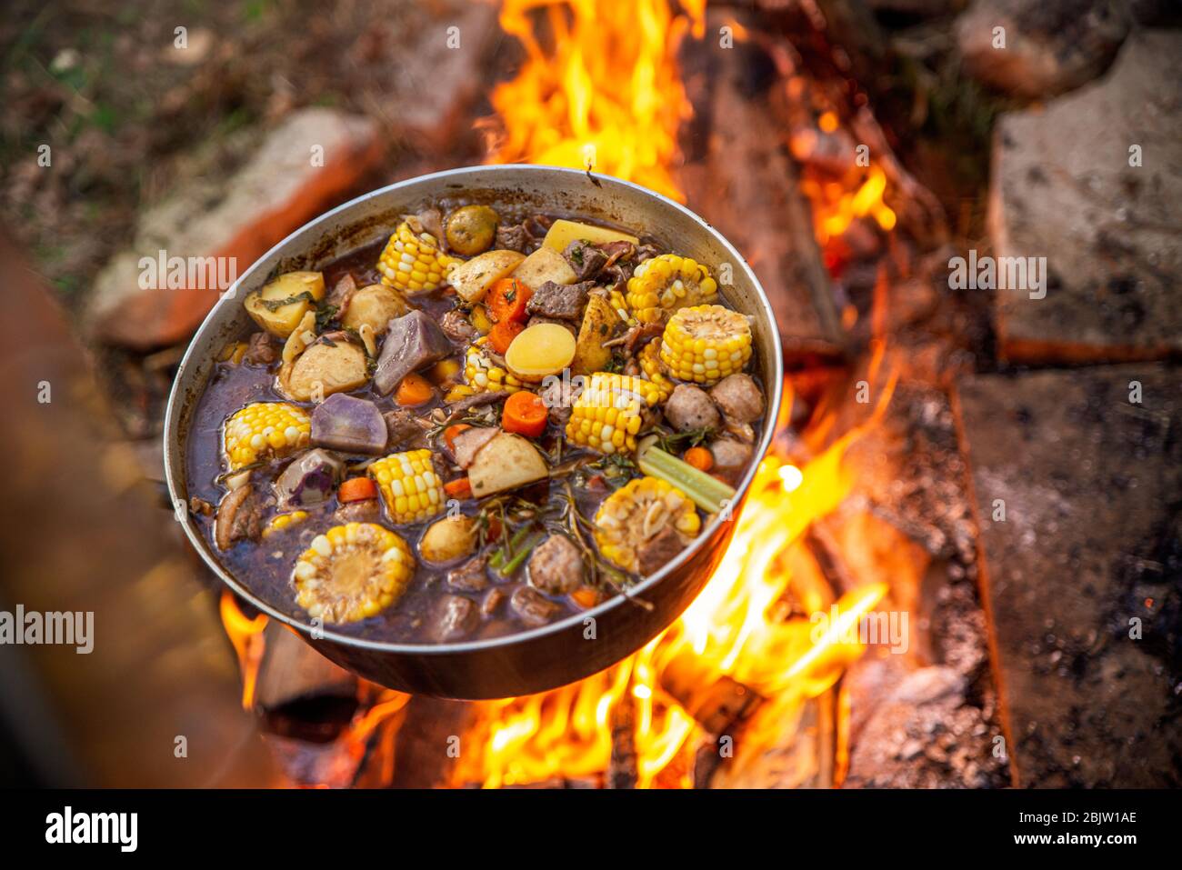 Kochen über einem Lagerfeuer mit geschmorten Speisen Stockfoto