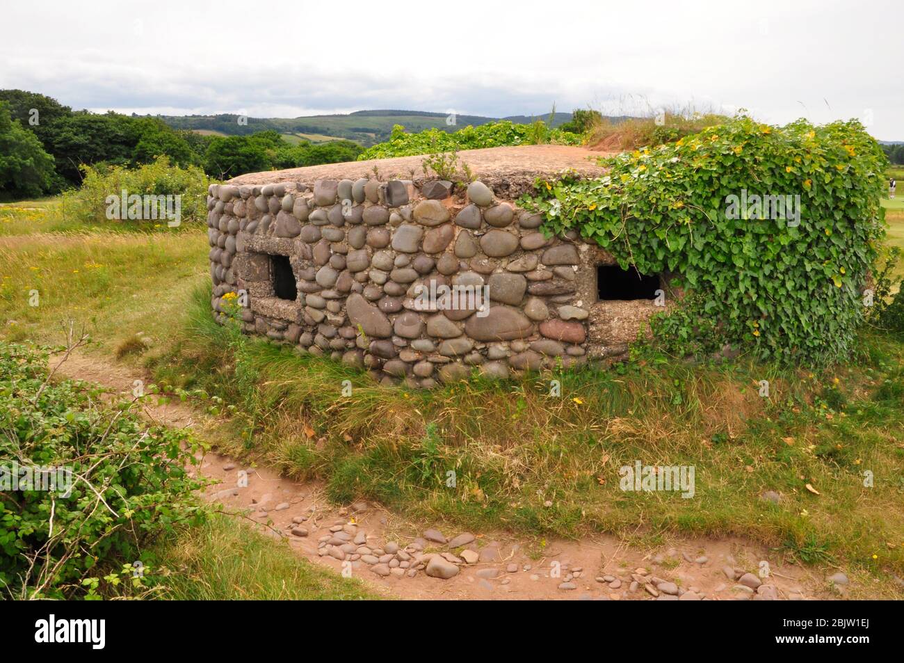 Pillendose aus dem Zweiten Weltkrieg, aus Beton gebaut, der mit Kieselsteinen am Strand bei Dunster in Somerset konfrontiert ist.Teil der Küstenverteidigung im 2. Weltkrieg.Somerset.UK Stockfoto