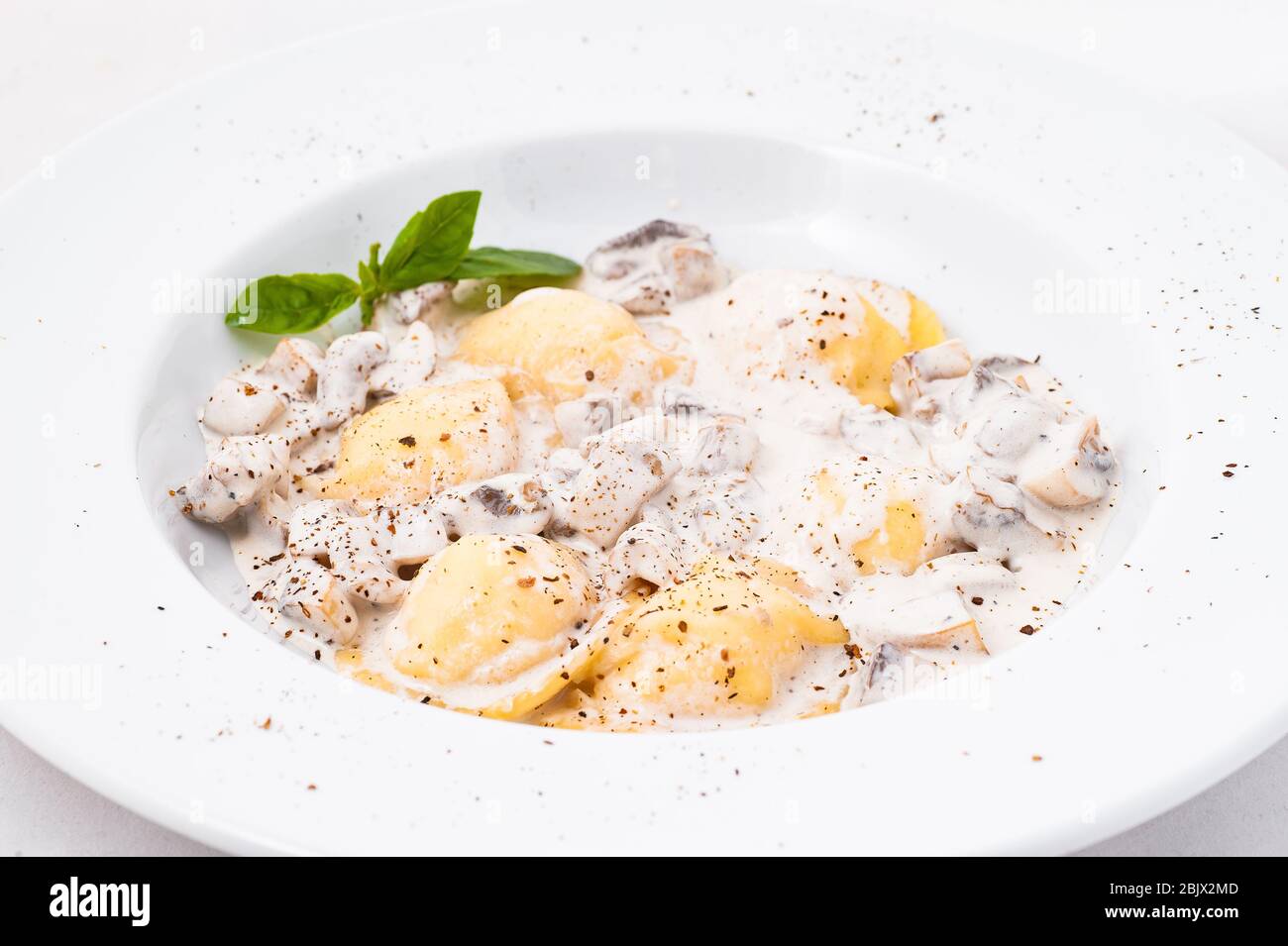 Ravioli mit Pilzen in cremiger Sauce. Stockfoto