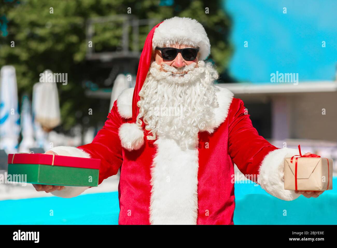 Cool Weihnachtsmann mit Geschenken an Resort Stockfoto