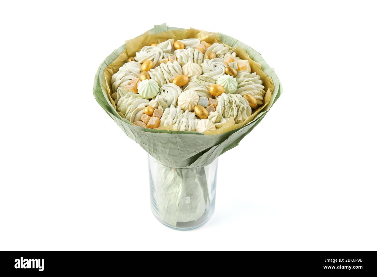 Ungewöhnlicher Strauß aus köstlichen handgefertigten Marshmallows in grünem Papier gewickelt, der in einer Vase auf weißem Hintergrund steht Stockfoto