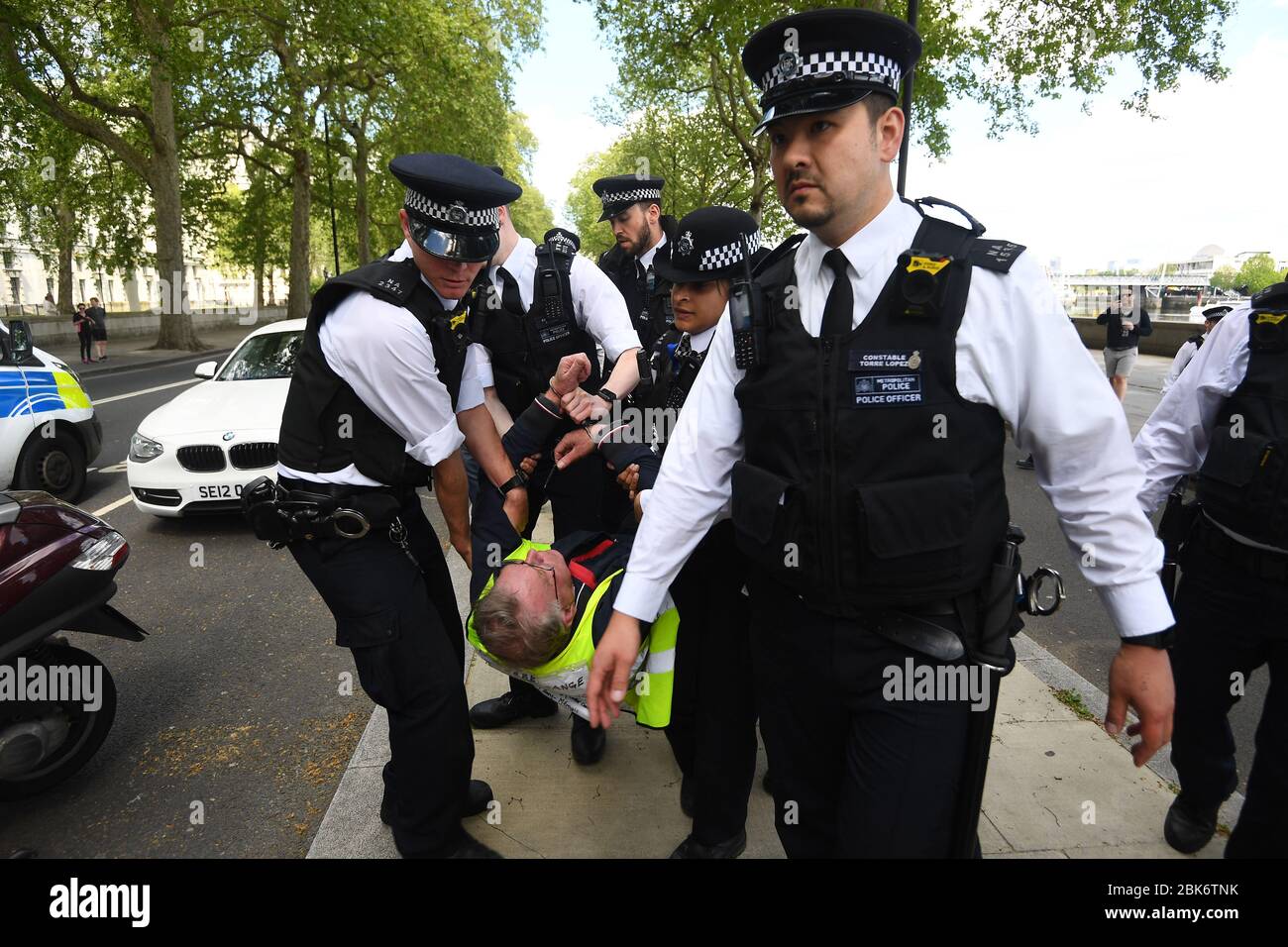 Ein Mann wird von Polizisten bei einem Protest gegen die Blockade von Covid-19 vor dem New Scotland Yard in London mitgenommen. Stockfoto