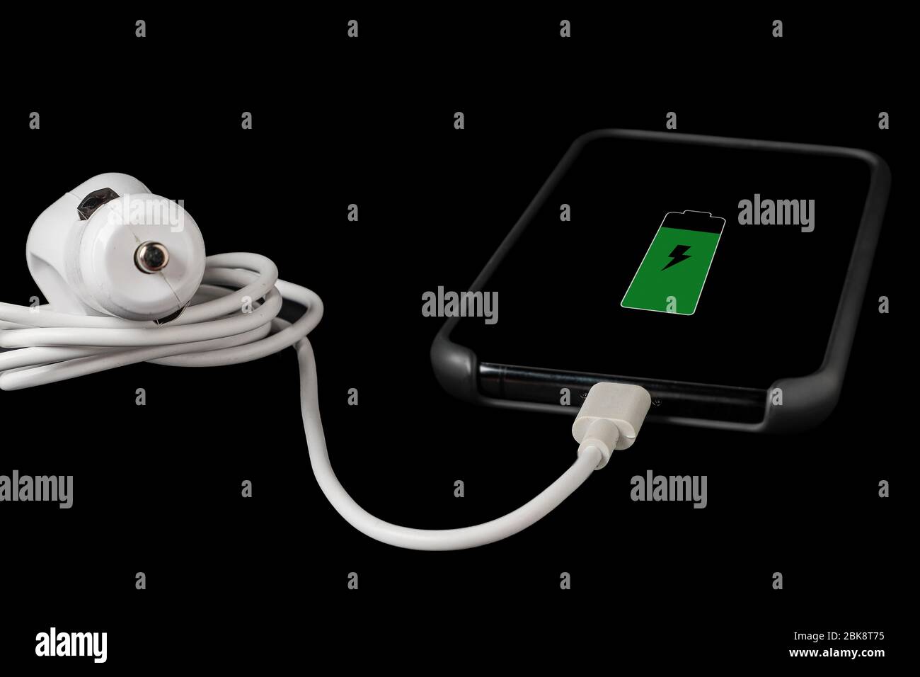 Horizontale Ansicht eines Mobiltelefons mit einem Akkusymbol, das mit einem weißen Autohellzeug verbunden ist, isoliert auf schwarzem Hintergrund Stockfoto