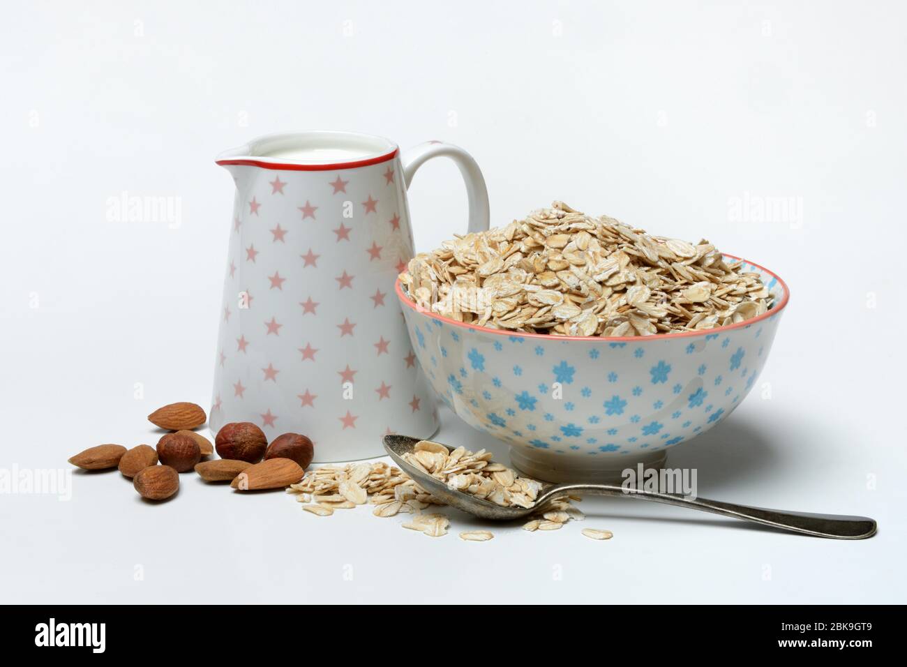 Haferflocken in Schale, Milch und Nüssen, Deutschland Stockfoto