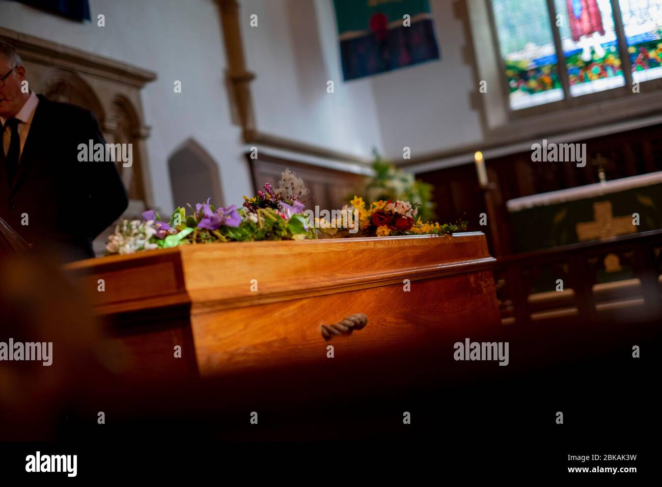 Einlone Sarg wartet, wie Trauerrede bei einer Beerdigung in einer ländlichen Kirche in Süd-UK Februar 2020 gelesen Stockfoto
