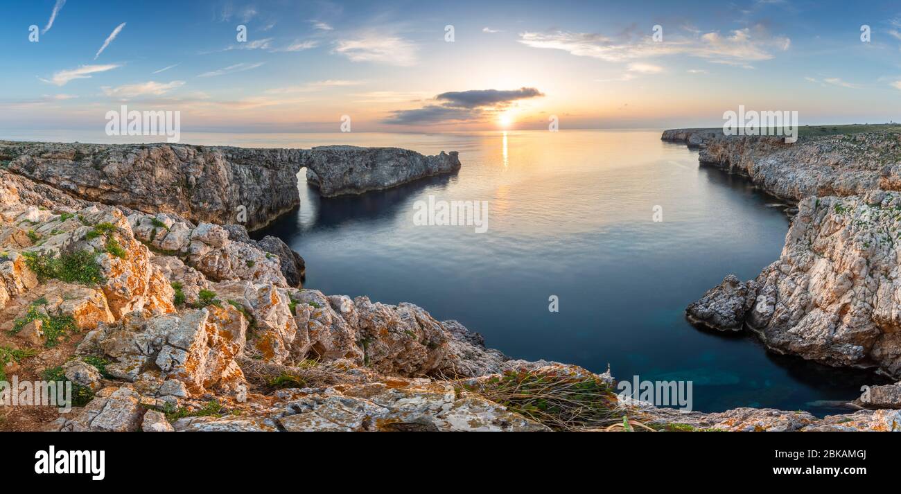 Panorama-Landschaft von Pont d'en Gil - ein natürlicher Felsbogen - bei Sonnenuntergang, in Menorca, Spanien Stockfoto