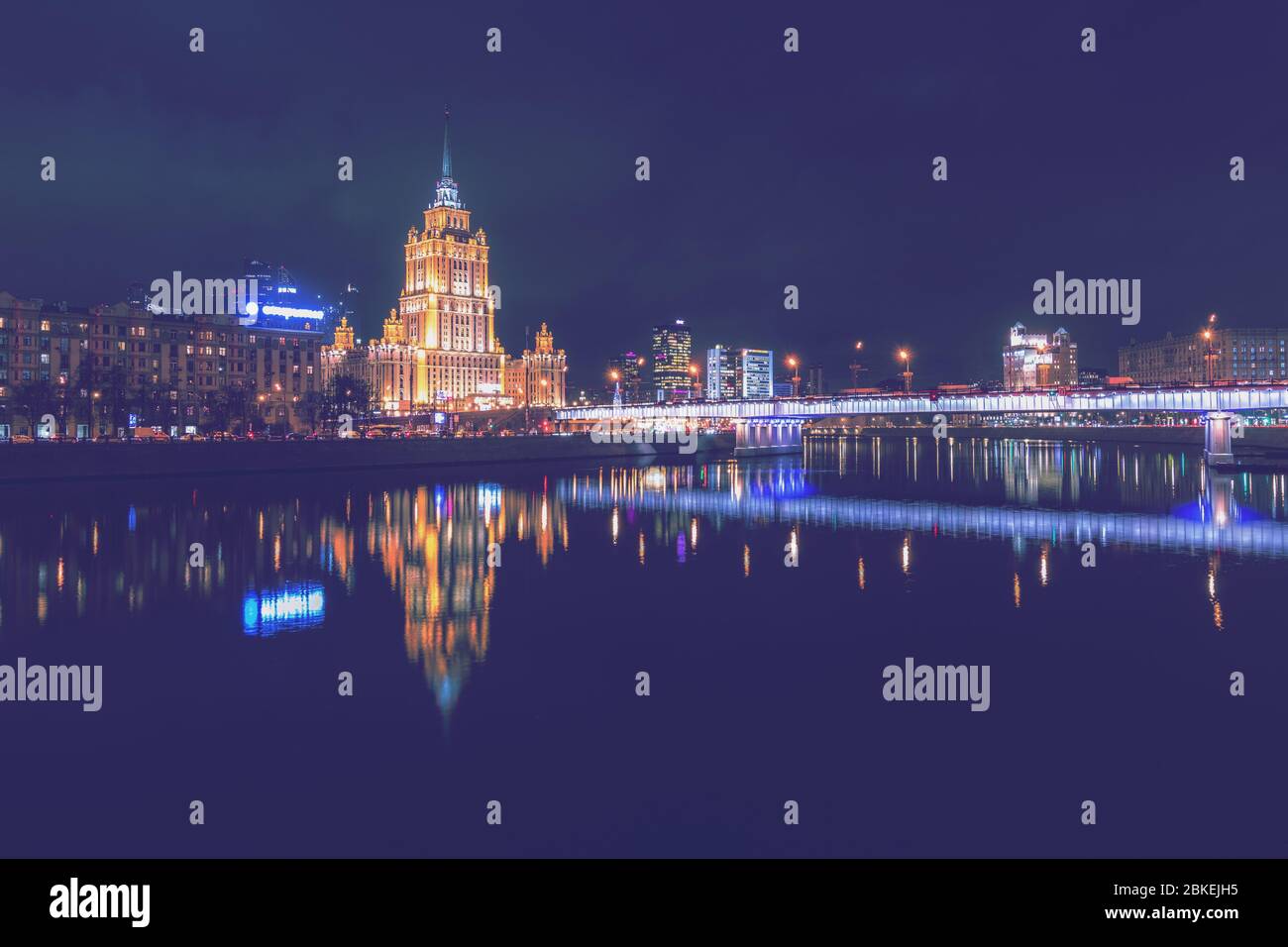 Hotel Ukraine oder Radisson, spiegelt sich in der Moskau River. Nachtlichter und Beleuchtung am Damm. Moskau, Russland. Stockfoto