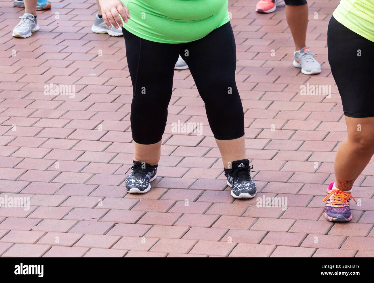 Übergewichtige Frau, die an Zumba-Klasse teilnimmt. Stockfoto
