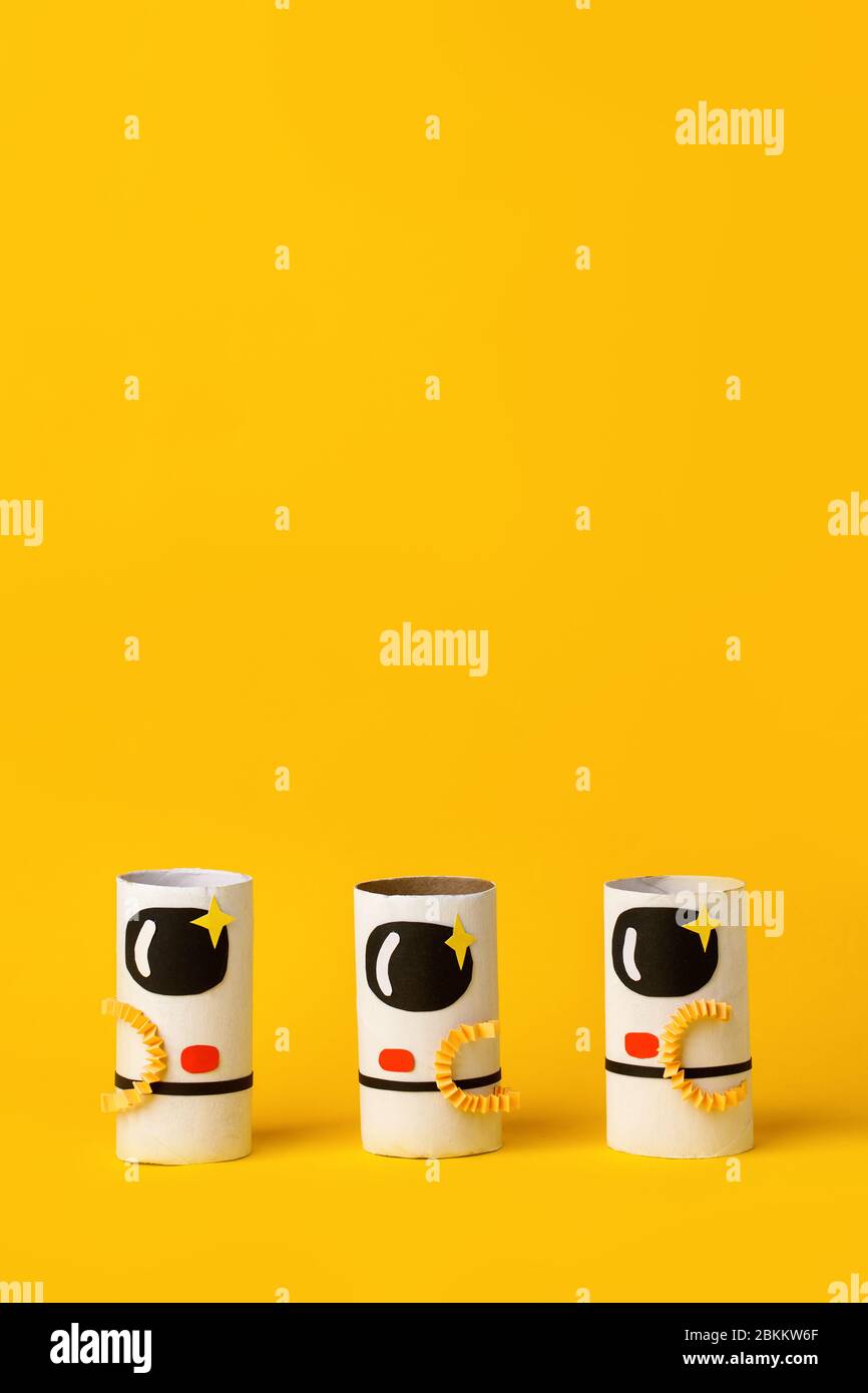 Spielzeug Astronaut auf gelbem Hintergrund mit Kopie Raum für Text. Konzept der Business-Launch, Start-up, Handwerk, diy, kreative Idee aus Toilettenröhre, re Stockfoto