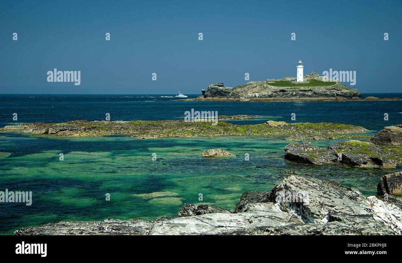 Ein Blick auf den Godrevy Lighthouse von den Felsen am Gwithian Beach an der North Cornwall Küste, Großbritannien Stockfoto