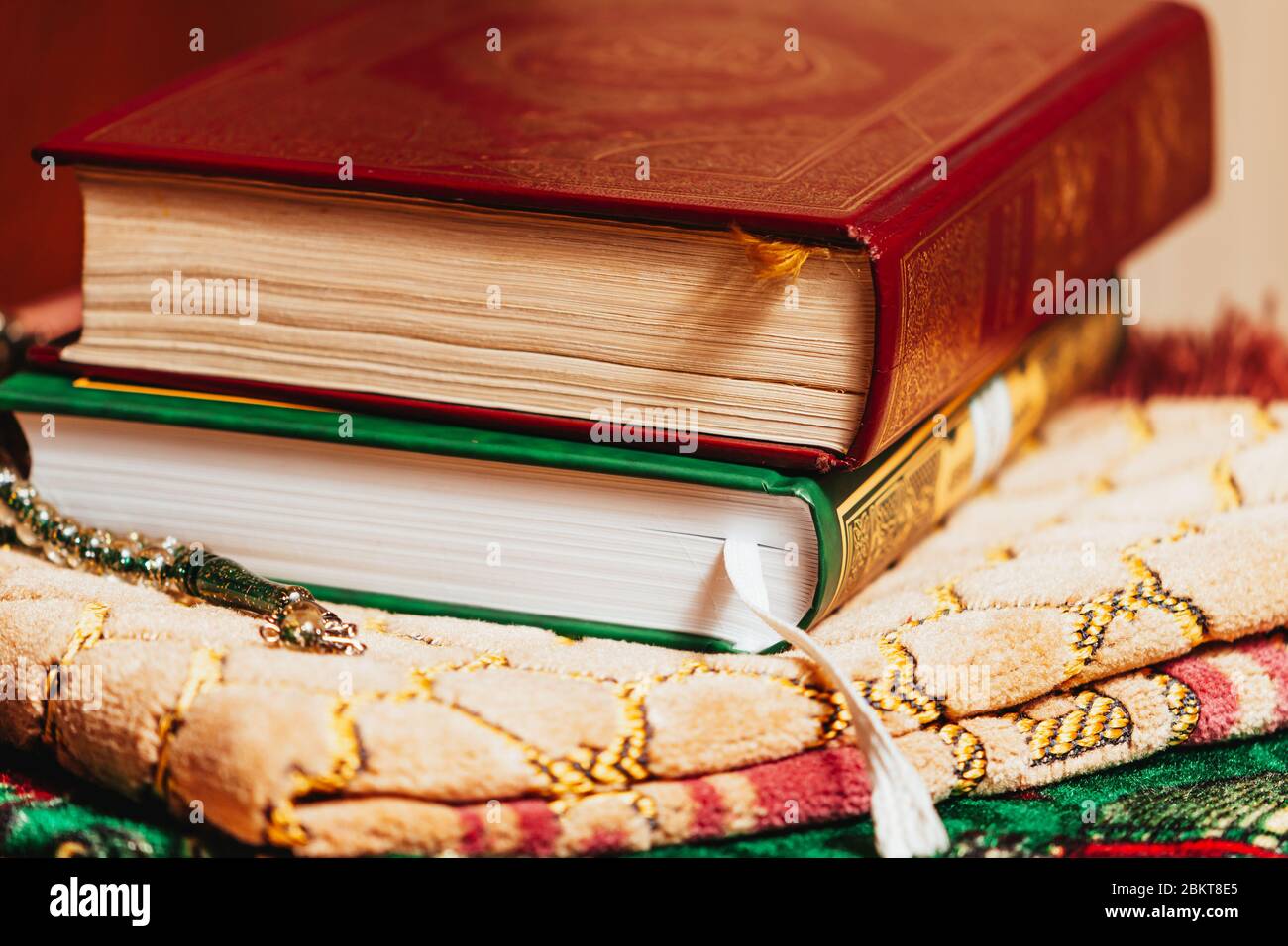Islamische religiöse Holly Bücher auf Gebetmatte in orientalischen Texturen Stockfoto