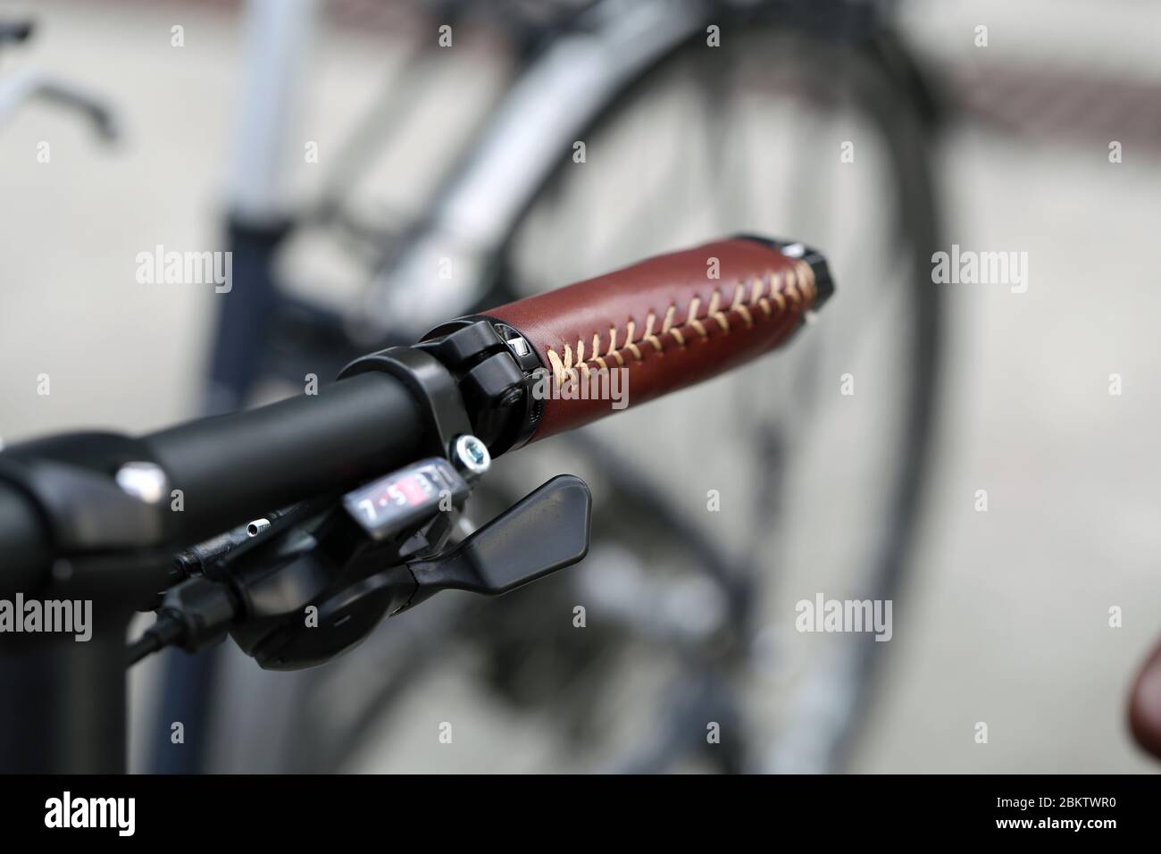 Nahaufnahme Farbbild Fahrradlenker mit braunen Lederdetails und schwarzer Ringglocke, Baden, Schweiz, März 2020. Fahrräder sind tolle Übung. Stockfoto