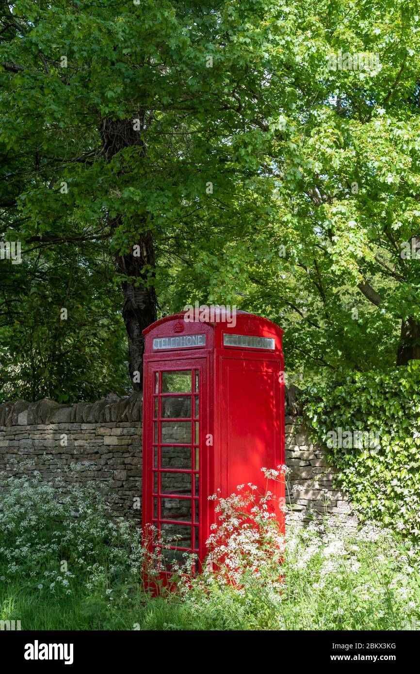 Altmodische rote Telefonbox im Retro-Stil in Swinbrook, The Cotswolds, Oxfordshire, Großbritannien Stockfoto