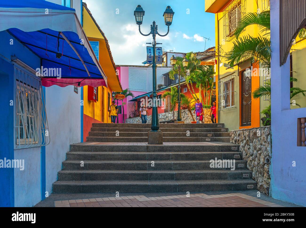 Junge Ecuadorianer, die die Treppe im farbenfrohen Viertel Las Penas auf dem Hügel Santa Ana mit kolonialer Architektur, Guayaquil, Ecuador, hinuntergehen. Stockfoto