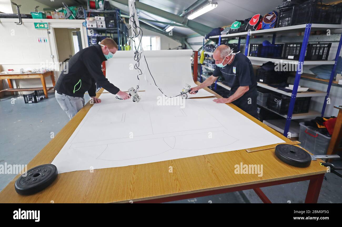 Johnny Dowling (links) und Joe Finnegan schneiden Schablonen in der Bekleidungsfabrik IntoSport in Castlecomer Co Killkenny, die während der Coronavirus-Krise von der Herstellung von GAA-Kleidung auf medizinische Scheuermittel umgestellt hat. Stockfoto