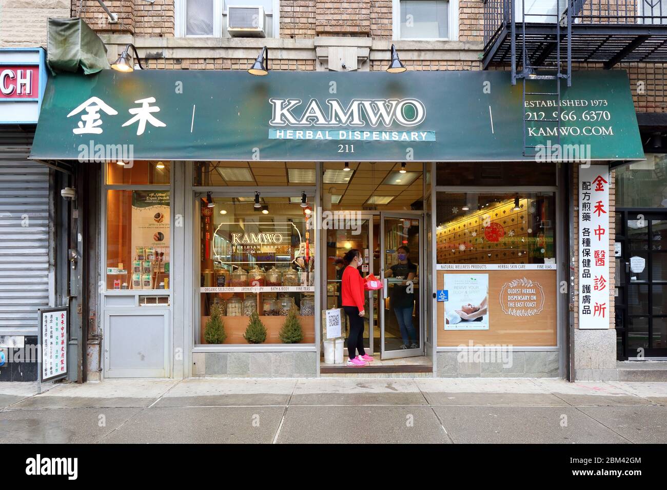 Eine Person holt Kräutermedizin von Kamwo in New York Chinatown ab, die wegen des Coronavirus für den Abholservice geöffnet ist... WEITERE INFORMATIONEN FINDEN SIE UNTER „VOLLSTÄNDIGE BILDUNTERSCHRIFT“ Stockfoto