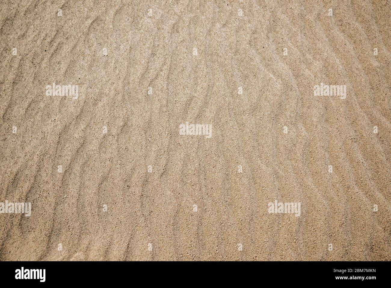 Sand mit Wellen, Textur oder Hintergrund Stockfoto