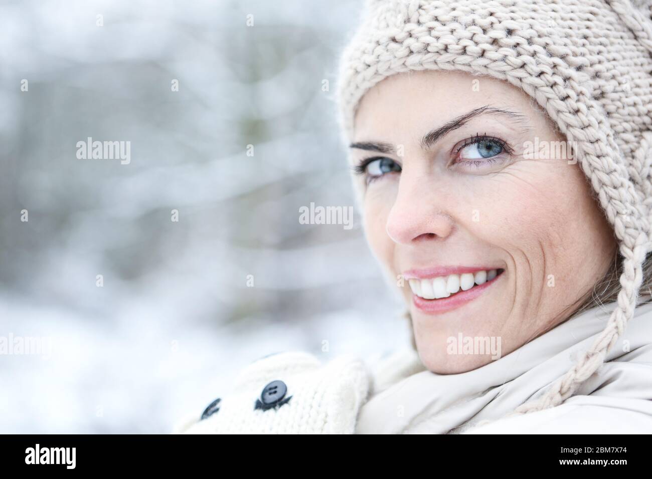 Lächelnde attraktive Frau im Winter im Freien Stockfoto