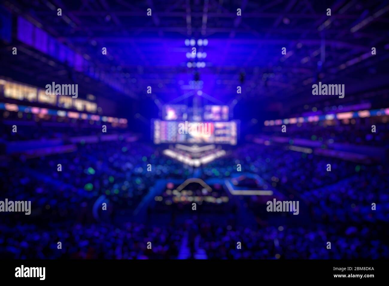 Verschwommener Hintergrund einer e sports Veranstaltung - Hauptbühnenort, Großbild und Lichter vor Turnierbeginn. Stockfoto