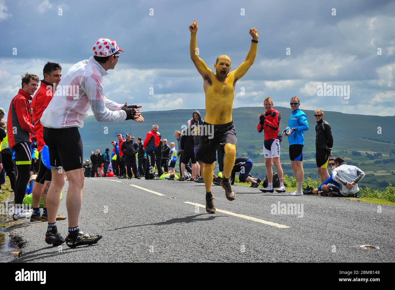 Zuschauer, darunter ein Mann, der mit gelber Farbe bedeckt läuft, beobachten das Rennen von der Cote de Butterwbs Climb Tour de France 2014 Climb of Butter Stockfoto