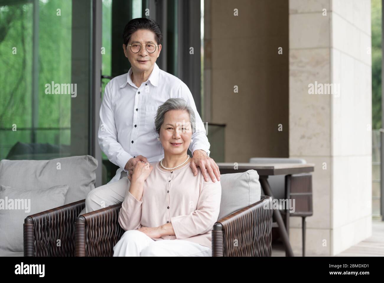 Ein asiatisches älteres Paar auf einem Outdoor-Stuhl Stockfoto