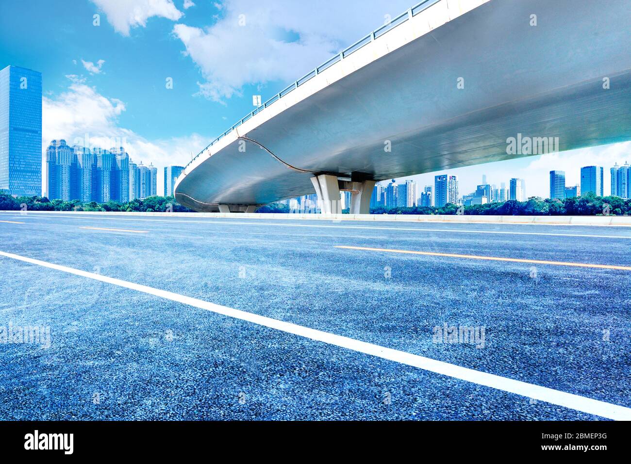 Unter der Überführung, autofreie Asphaltstraße, moderne Skyline des Stadtgebäudes als Hintergrund. Stockfoto