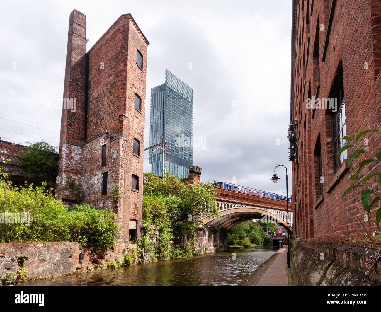 Manchester, England, Großbritannien - 21. Mai 2011: Ein Industriemotorenhaus und der moderne Wolkenkratzer Beetham Tower ragen über dem Bridgewater Canal und railwa Stockfoto