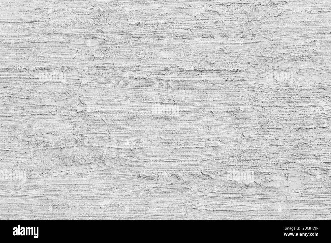 Nahaufnahme einer verputzten & rauhen Betonwand in weiß oder hellgrau lackiert, handgefertigte Stuckstruktur. Vollformat texturierter Hintergrund in schwarz & weiß. Stockfoto