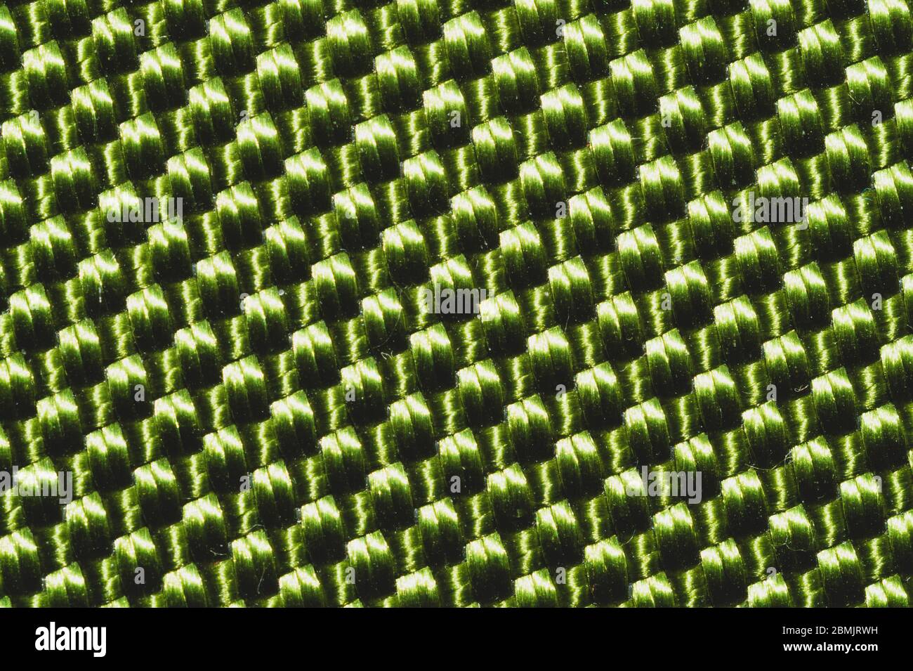 Synthetische Gewebe Textur Nahaufnahme. Grüne geflochtene Oberfläche. Gewebter Hintergrund. Nähte von Fasern Stockfoto