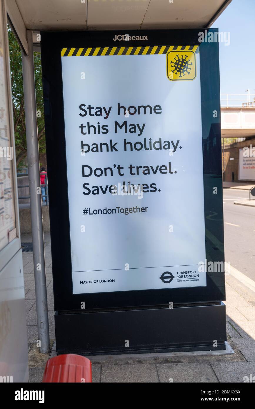 Ein vierblattblattes Poster an einer Bushaltestelle, das Reisende bittet, während der Coronavirus-Pandemie zu Hause zu bleiben. Stockfoto