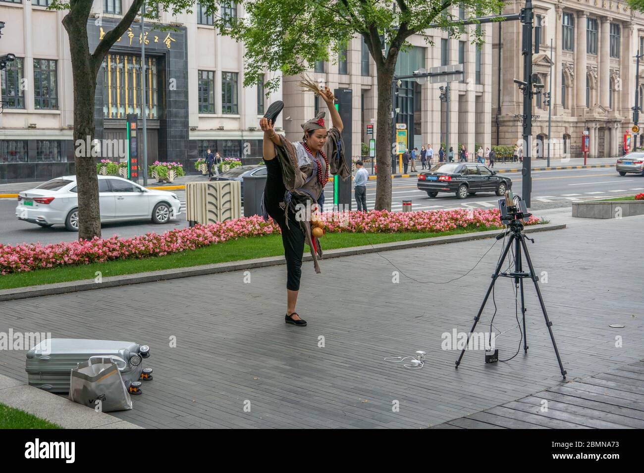 10. Mai 2020, Shanghai, Shanghai, China: ShanghaiÃ¯Â¼Å'CHINA-EINE als Glücksfürst verkleidete weibliche Ankerin sendet live auf der Straße der shangdong Straße im zentralen bund am Mittag in Shanghai, 8. Mai 2020. Die ''Dame'' trägt eine gebrochene Soutane, einen Mönchshut auf seinem Kopf, einen gebrochenen pu-Fächer, einen Kalabasch und eine Buddha-Perle und sieht sehr lebensecht aus. Ihre Live-Streaming-Ausrüstung ist auch sehr professionell, mit zwei Handys und einem Ladegerät auf einem Stativ, sie ist ständig mit ihren Fans interagieren und einige einfache Talent.Laut der Anchorwoman selbst, hat sie mehr t Stockfoto