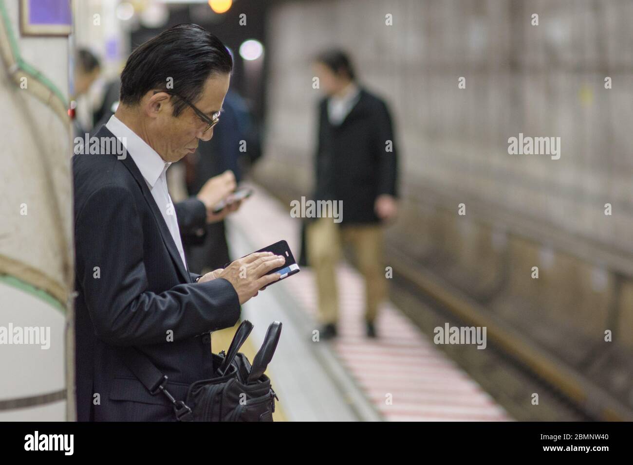 Tokio / Japan - 19. April 2018: Geschäftsmann wartet auf eine U-Bahn in Tokio Stockfoto