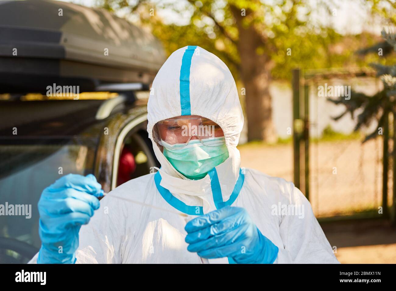Medic nimmt Coronavirus Schnelltest als Kehlschmierling in Drive-in-Teststation Stockfoto