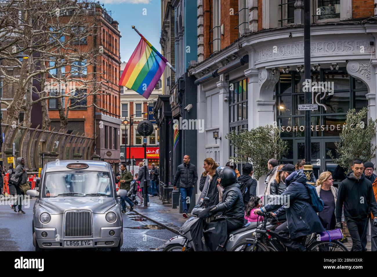 LGBT-Flagge in Soho, London. Leute, die in Soho London, Brewer Street, spazieren gehen Stockfoto
