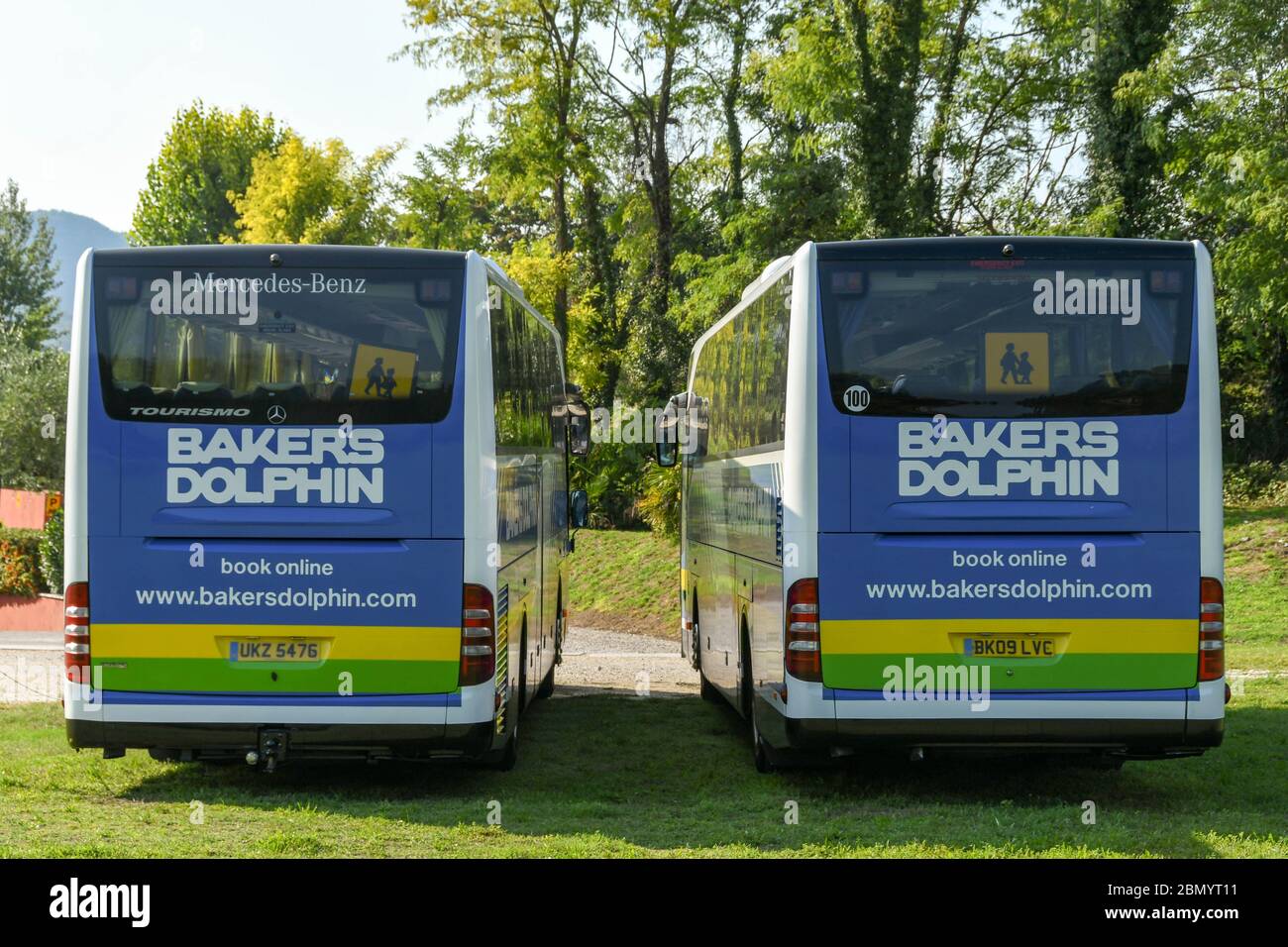 GARDA, GARDASEE, ITALIEN - SEPTEMBER 2018: Zwei Busse des britischen Reiseunternehmens Bakers Dolphin parkten nebeneinander auf dem Hotelgelände Stockfoto