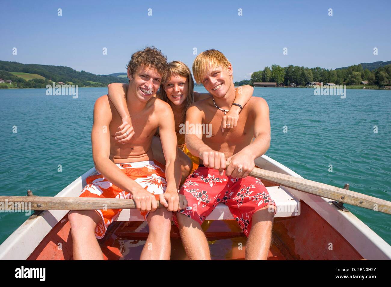 Drei Jugendliche sitzen in einem Ruderboot, 18 Jahre, Irrsee, Oberösterreich, Österreich Stockfoto