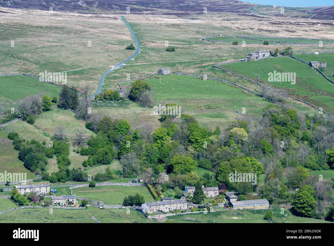 Dorf Low Row in Swaledale, Blick von der High Lane in Richtung Brownsey Moor im Frühjahr. North Yorkshire, Großbritannien. Stockfoto