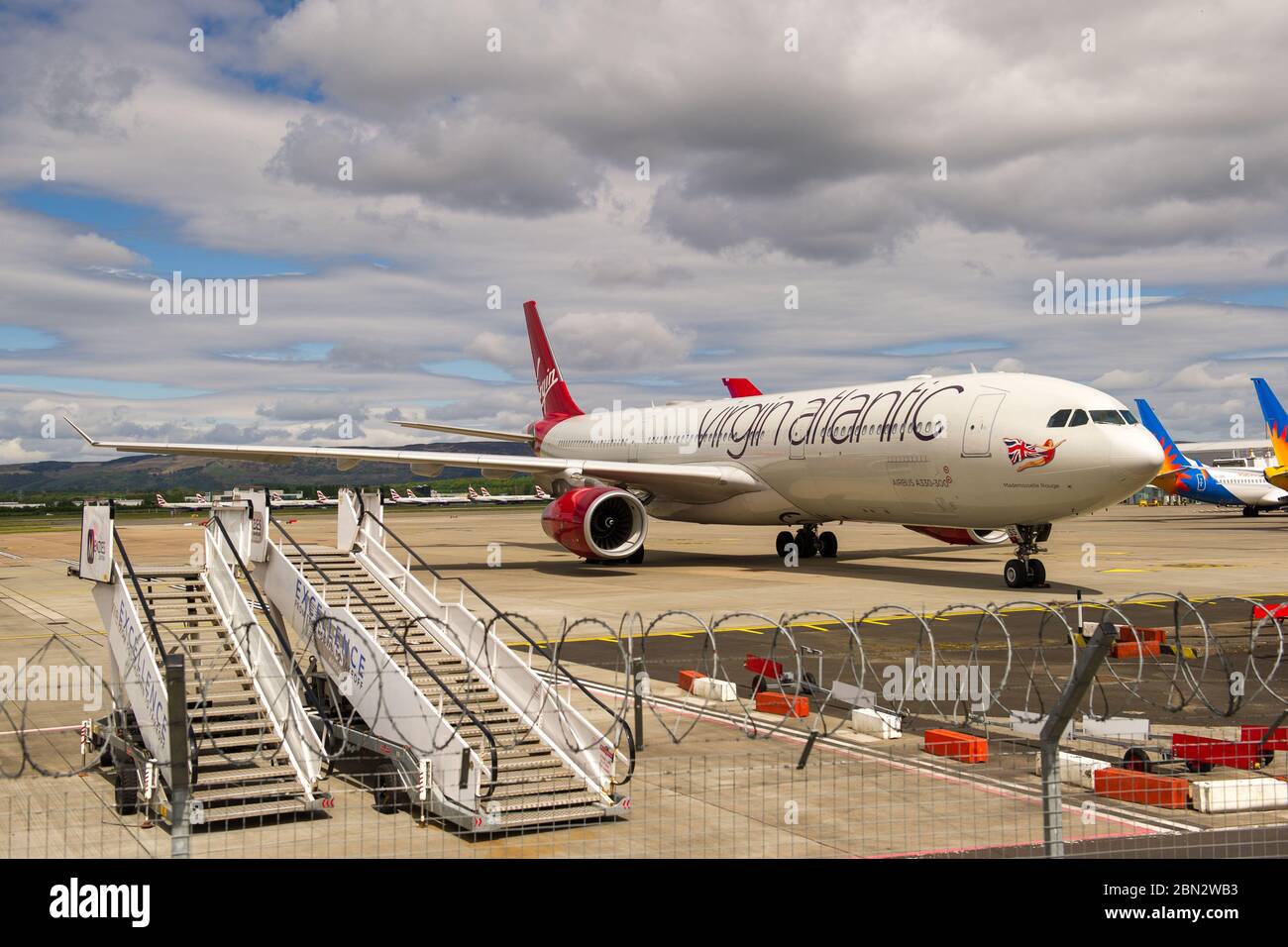 Glasgow, Großbritannien. Mai 2020. Bild: Virgin Atlantic zieht während der verlängerten Sperrung des Coronavirus (COVID19) mehr Flugzeuge zum Flughafen Glasgow um. Auf dem Tarmac sind zwei Boeing 747-400 und zwei Airbus A330-300 Flugzeuge amongst4 die andere Anzahl von Bodenflugzeugen von verschiedenen Fluggesellschaften, die das gleiche oder ähnliche Schicksal bei Virgin konfrontiert. Virgin Atlantic kündigte an, dass sie ihre Operationen in Gatwick auf unbestimmte Zeit schließen werden, was für den Südosten Großbritanniens massive Auswirkungen haben wird. Quelle: Colin Fisher/Alamy Live News Stockfoto