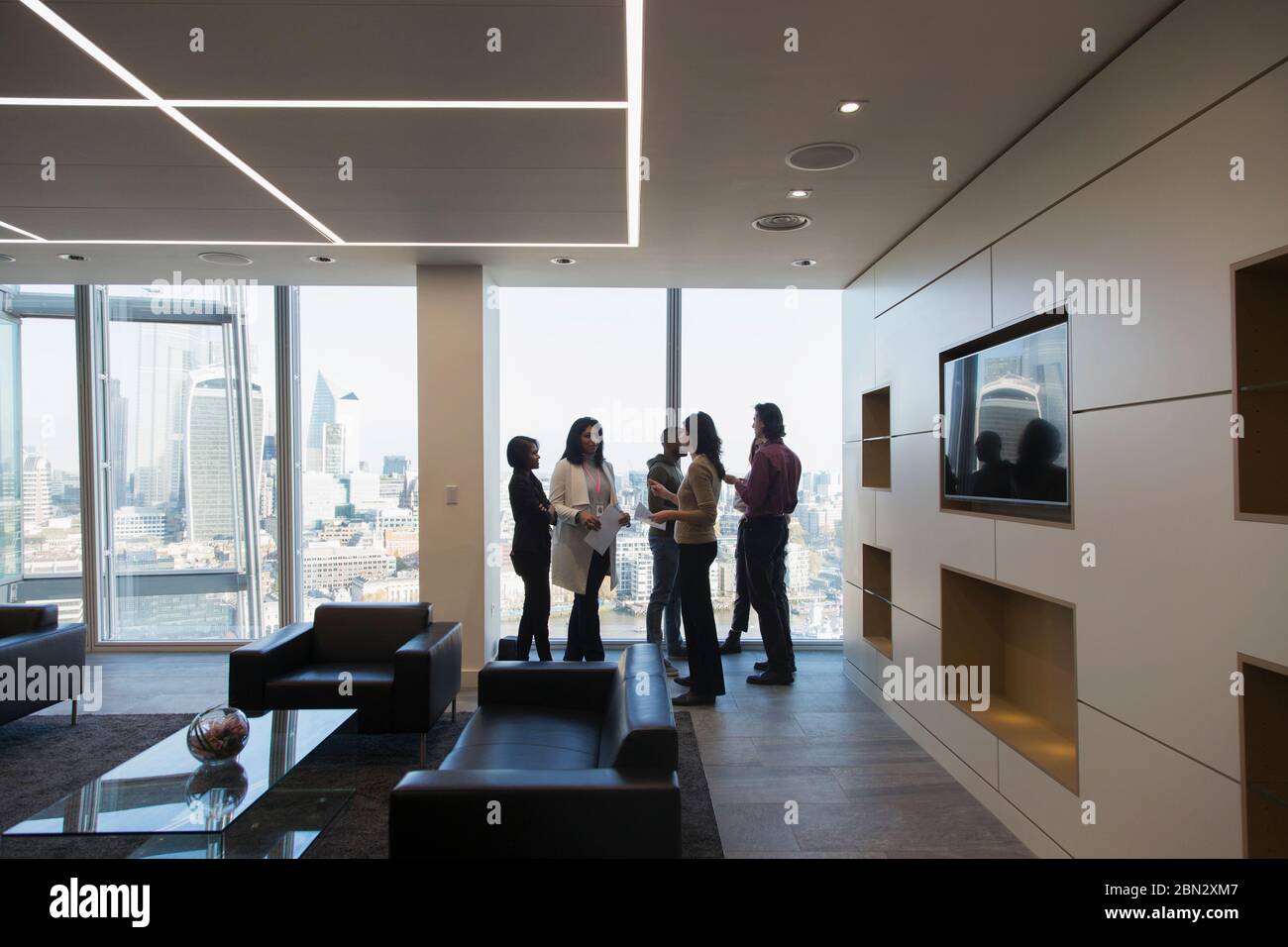 Geschäftsleute sprechen in der modernen Bürolobby Stockfoto