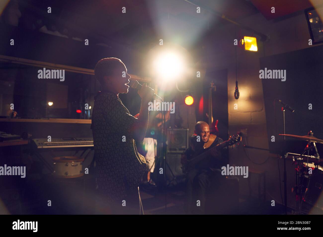 Musikerin singt ins Mikrofon im Aufnahmestudio Stockfoto